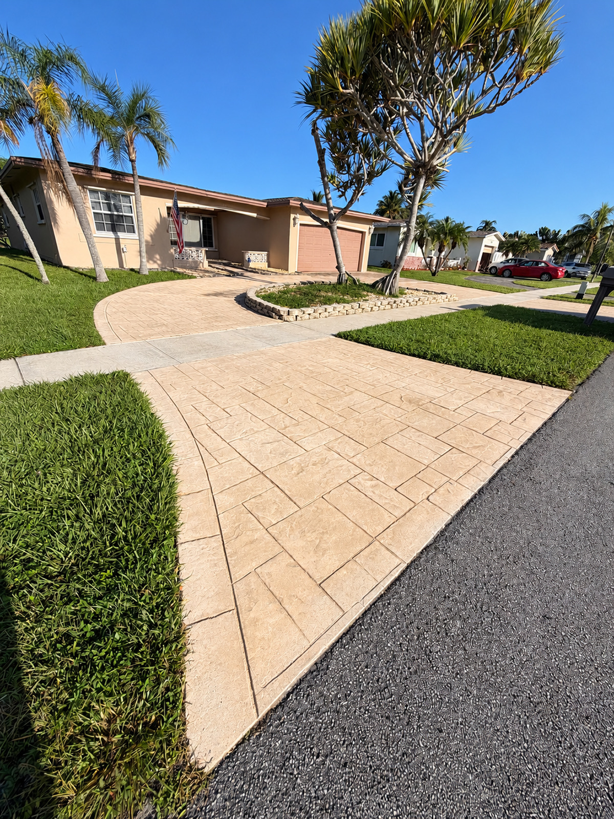 The same stamped concrete driveway in Weston with its original color after pressure washing